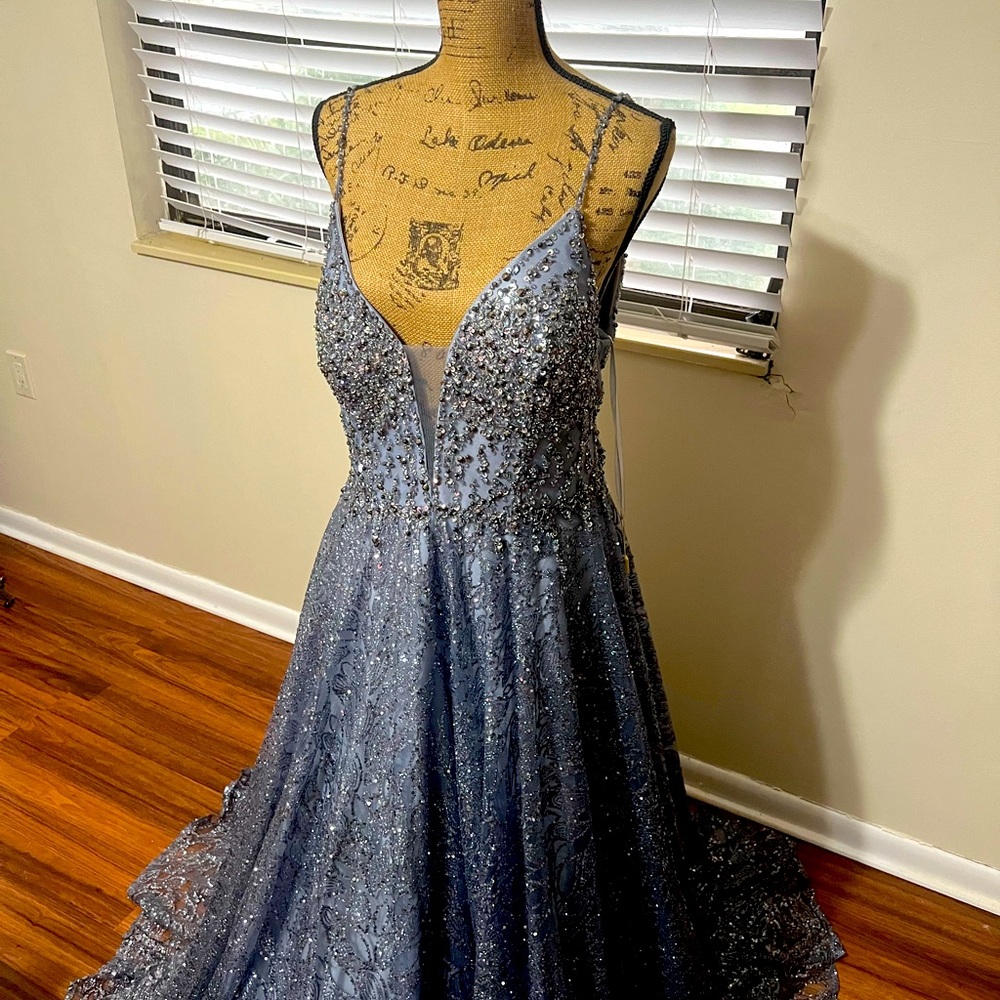 selling this blue and silver prom dress. never been worn and still has tag